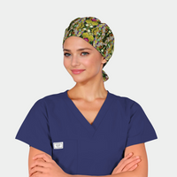 girl with a navy scrub top on and a botanic patterned scrub hat that has green leaves