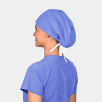 A person viewed from the back wearing a blue scrub hat with a tie at the neck.