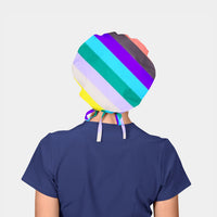 Person wearing a colorful striped bouffant scrub cap on a plain background
