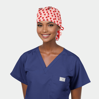 Person wearing blue scrubs and a red heart-patterned cap on a white background