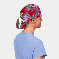Person wearing a ponytail floral scrub cap on a plain background