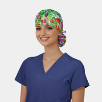 Person wearing a blue scrub top and ponytail scrub hat with vegetables on it on a light gray background