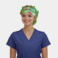 Person wearing a blue scrub top and colorful scrub hat with vegetables on it on a white background