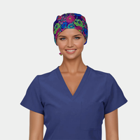 Person wearing a blue scrub top and colorful floral headscarf on a white background