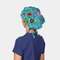 Person wearing a colorful floral bouffant scrub hat on a plain background