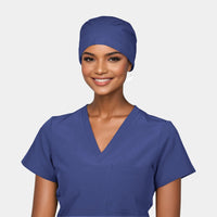 A woman wearing a navy blue scrub hat and matching scrub top.