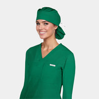 A person wearing a hunter green scrub hat and matching green scrub suit.