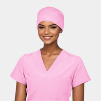 A woman wearing a solid pink scrub cap and matching scrub top.