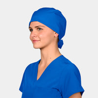 A person wearing a royal blue scrub hat tied at the back, matching with a blue scrub top.