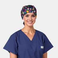 woman wearing a navy blue scrub top and a christmas scrub hat that is navey with snowmen and christmas trees