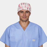 Man wearing light blue medical scrubs with a scrub cap that has pink guitars on it on a white background