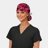woman wearing a black scrub top and a ponytail scrub cap that has pink and red flowers on it