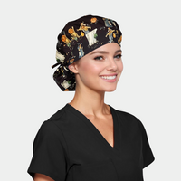 woman wearing a black scrub top and a halloween bouffant scrub cap that has ghosts, and cats and scarecrows