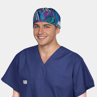 man wearing a navy blue scrub top and a scrub hat with a wavy pattern of blues and purples.