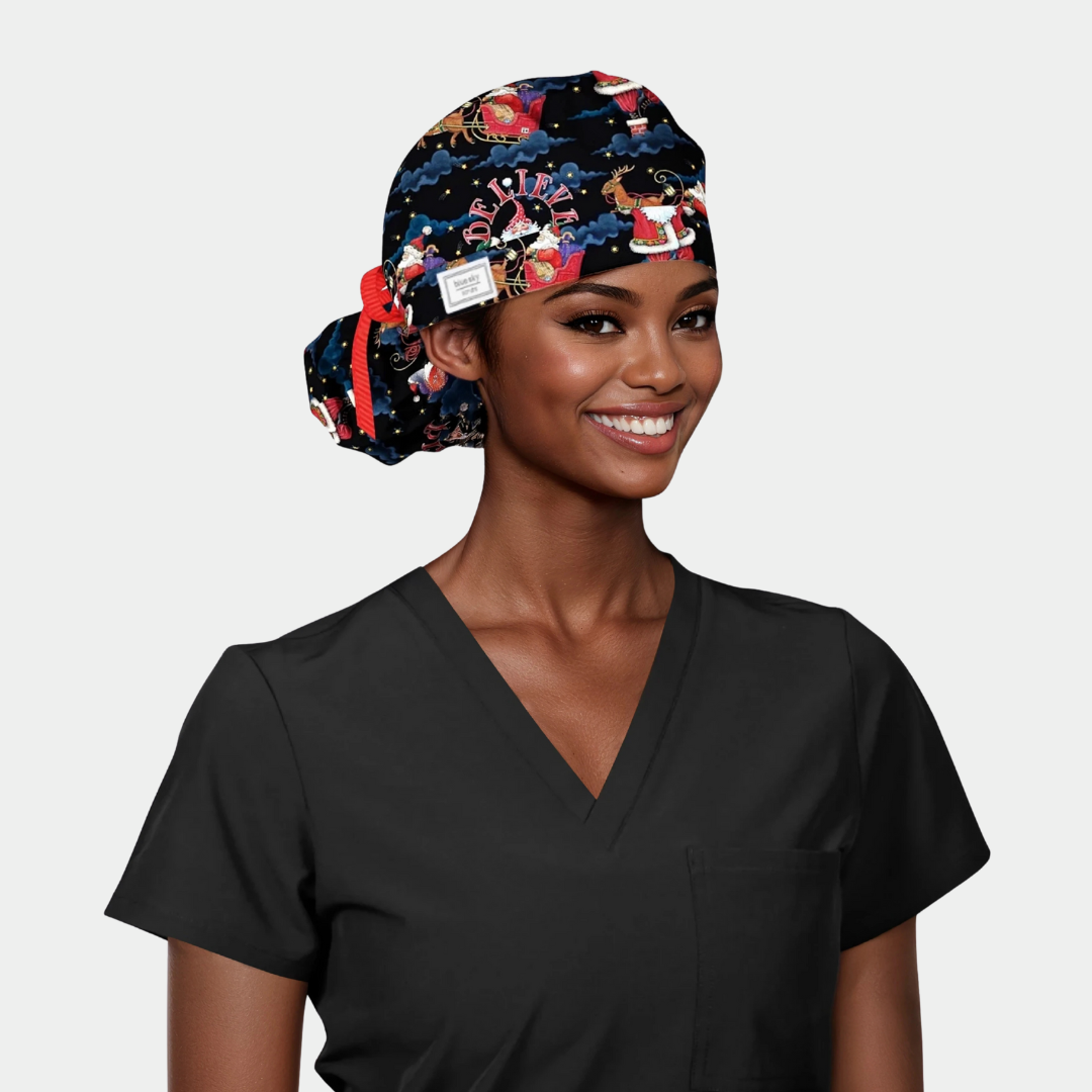 Woman wearing a christmas scrub cap and black scrub top on a light gray background