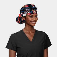 Woman wearing a christmas scrub cap and black scrub top on a light gray background