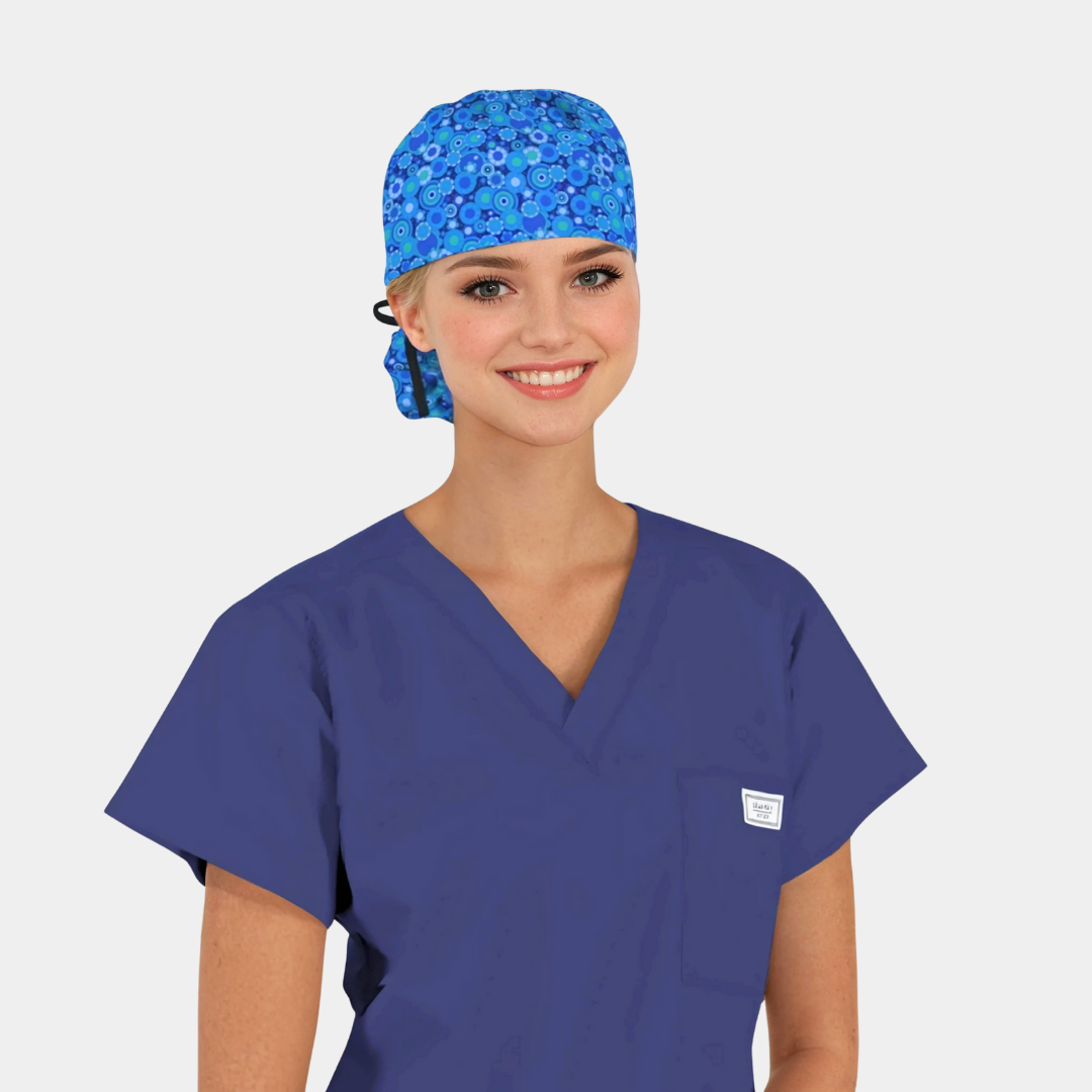 girl wearing a navy blue scrub top and a blue patterned scrub hat with a black ribbon
