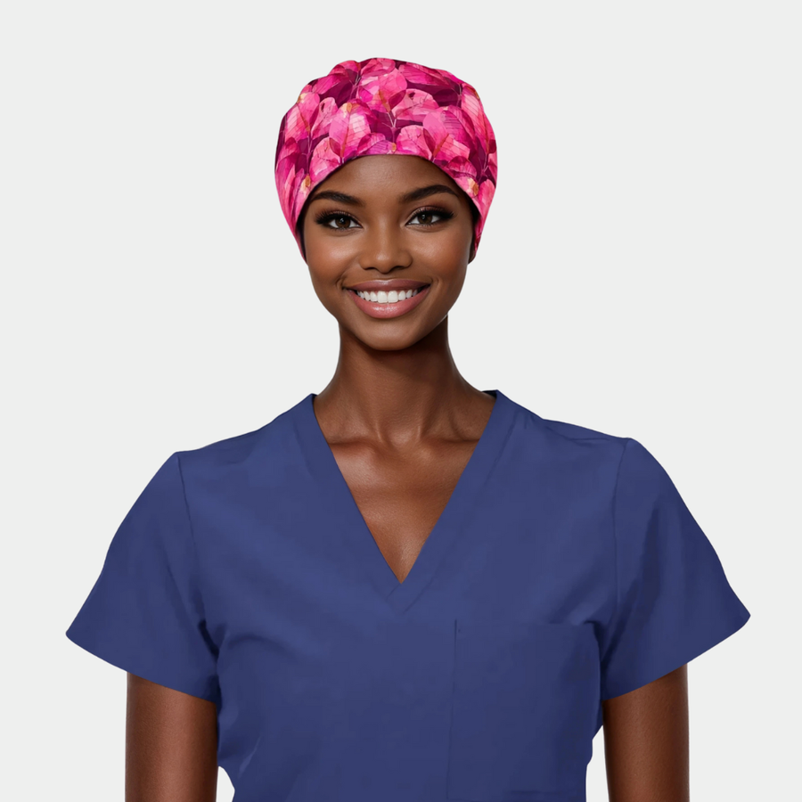 woman wearing a navy blue scrub top and a pink floral scrub hat