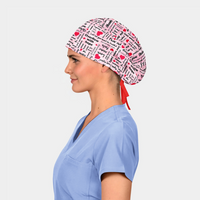 woman wearing a pink scrub hat with words and hearts on it and a light blue scrub top