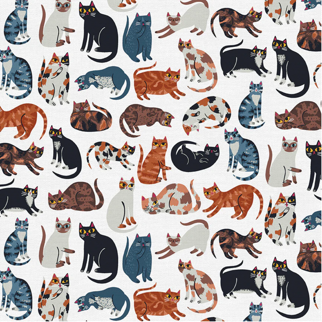 scrub cap fabric with various cats all over it on a white background