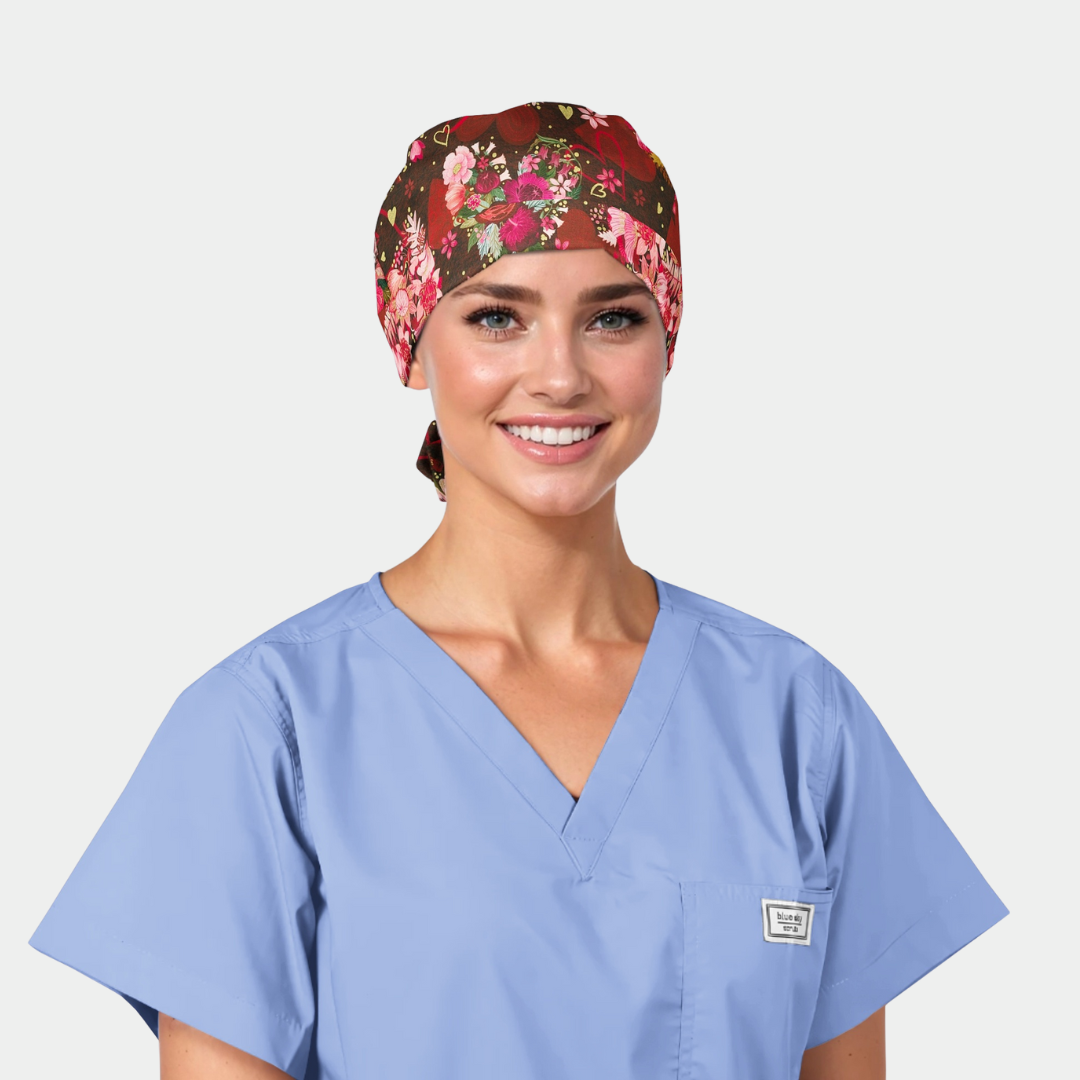 woman wearing a floral scrub cap and a light blue scrub top