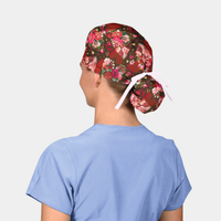 woman wearing a ponytail scrub cap that is brown with hearts and flowers on it