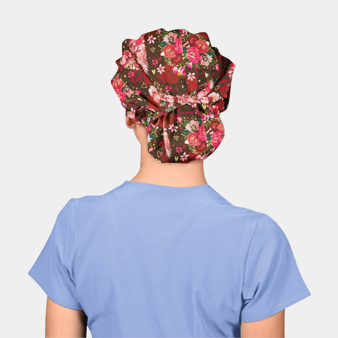 Person wearing a floral patterned scrub cap on a plain background