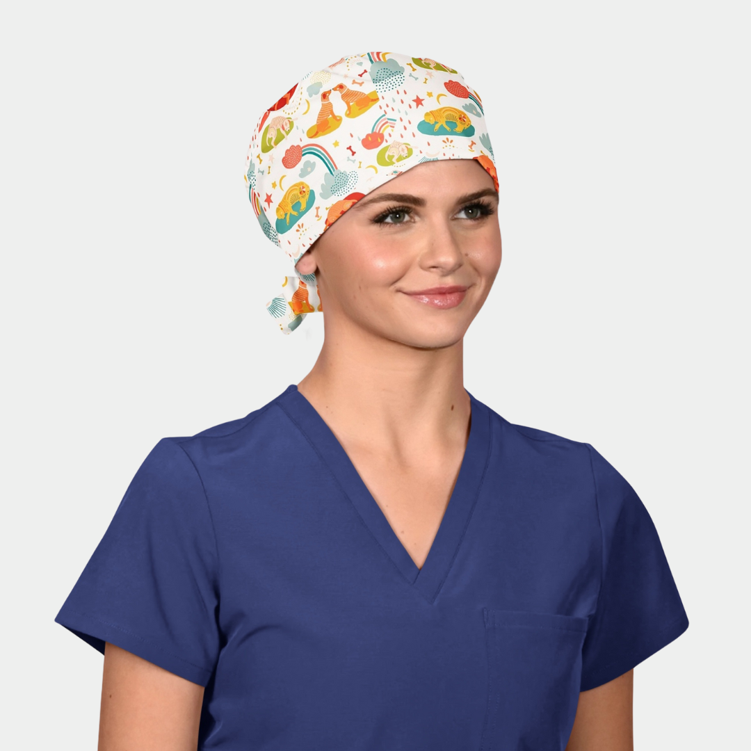 girl wearing a navy scrub top and a white scrub cap with dogs on it