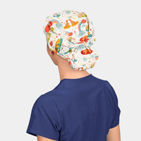 woman wearing a navy scrub top and a white bouffant scrub hat with 