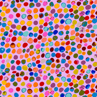 scrub cap fabric with multicolored polka dots on a pink background