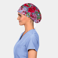 Person wearing a floral scrub cap and blue scrubs on a white background