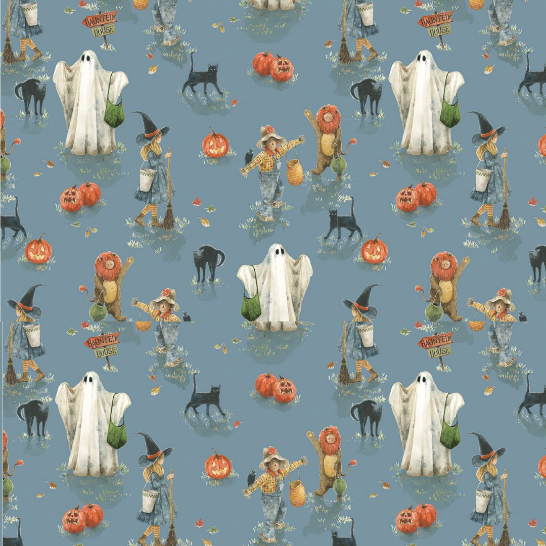 halloween scrub hat fabric that has pumpking, ghosts and scarecrows on a blue background
