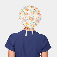 woman wearing a navy blue scrub top and a cream colored bouffant hat with houses, pools and palm trees on it