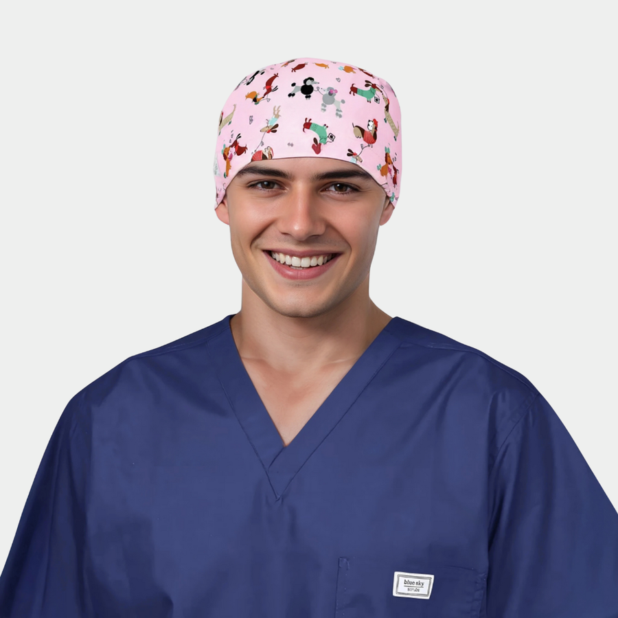 man wearing a navy scrub top and a pink scrub hat with dogs on it