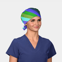 Woman wearing a colorful striped surgical cap and blue scrub top on a white background
