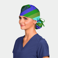Person wearing a colorful striped headscarf and blue scrub top on a white background