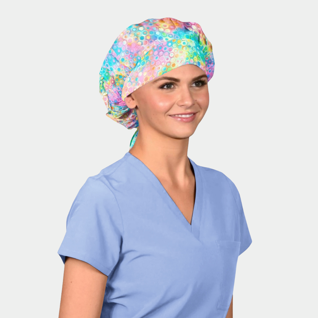 Person wearing a colorful pastel scrub cap and light blue scrub top on a white background