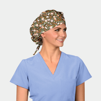 woman wearing a light blue scrub top and a bouffant scrub hat that is brown with flowers on it