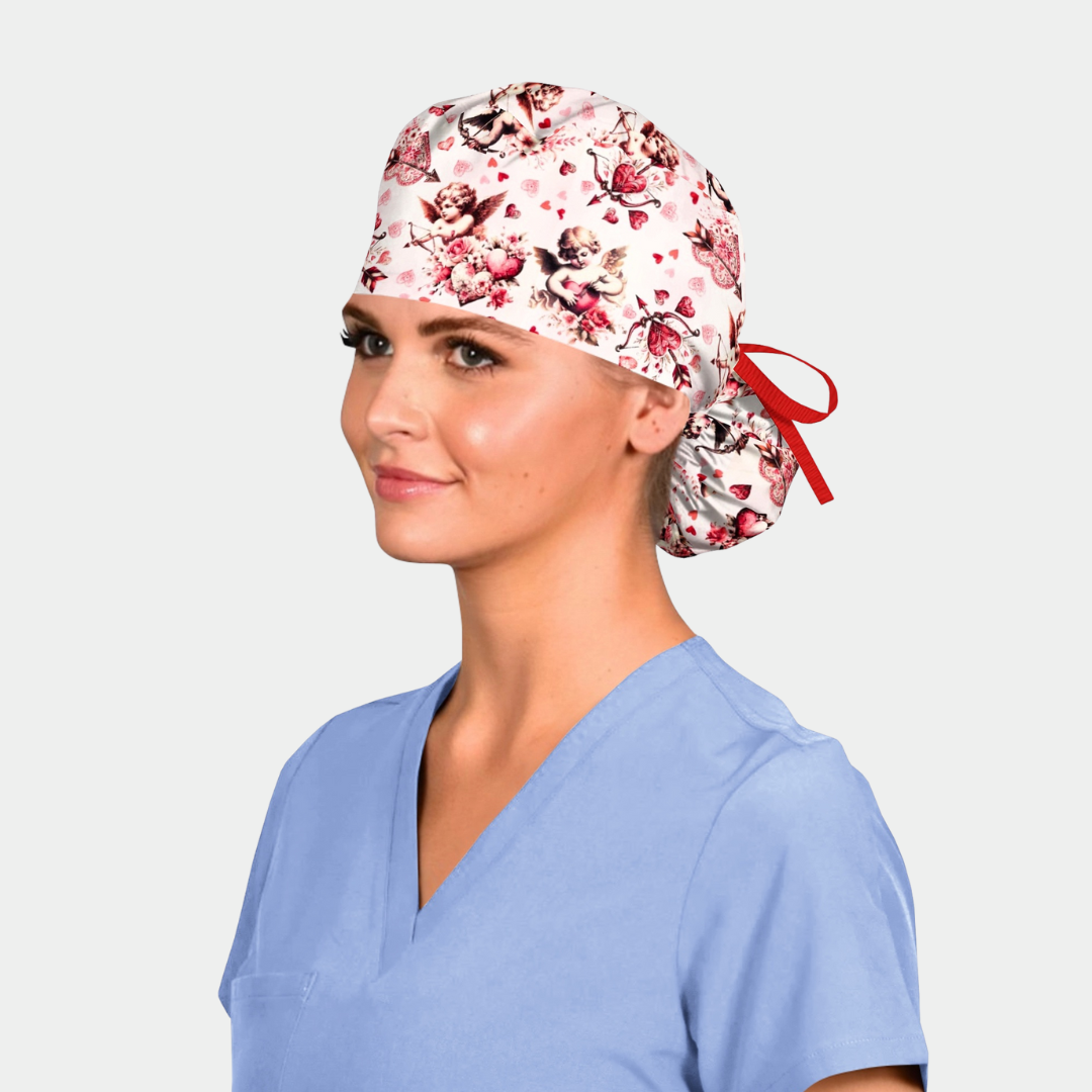 Woman wearing a valentines scrub cap and blue scrubs on a white background