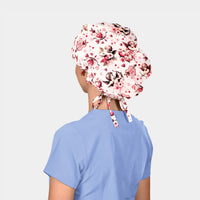 Person wearing a valentines bouffant scrub cap on a plain background