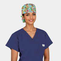 Person wearing a blue scrub top and colorful floral scrub cap on a white background