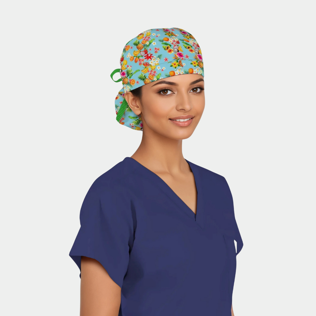 Person wearing a colorful floral scrub cap and blue scrub top on a light gray background