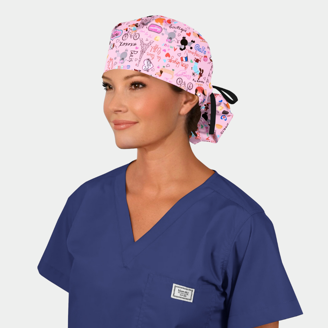 woman wearing a navy scrub top and a pink ponytail scrub hat with a black ribbon