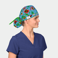 Person wearing a colorful floral-patterned scrub cap and blue scrub top on a light gray background
