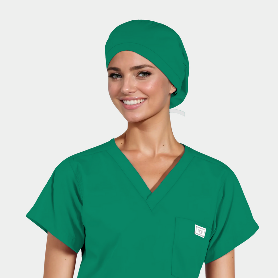 woman wearing a solid green scrub cap and a green scrub top on a light grey background