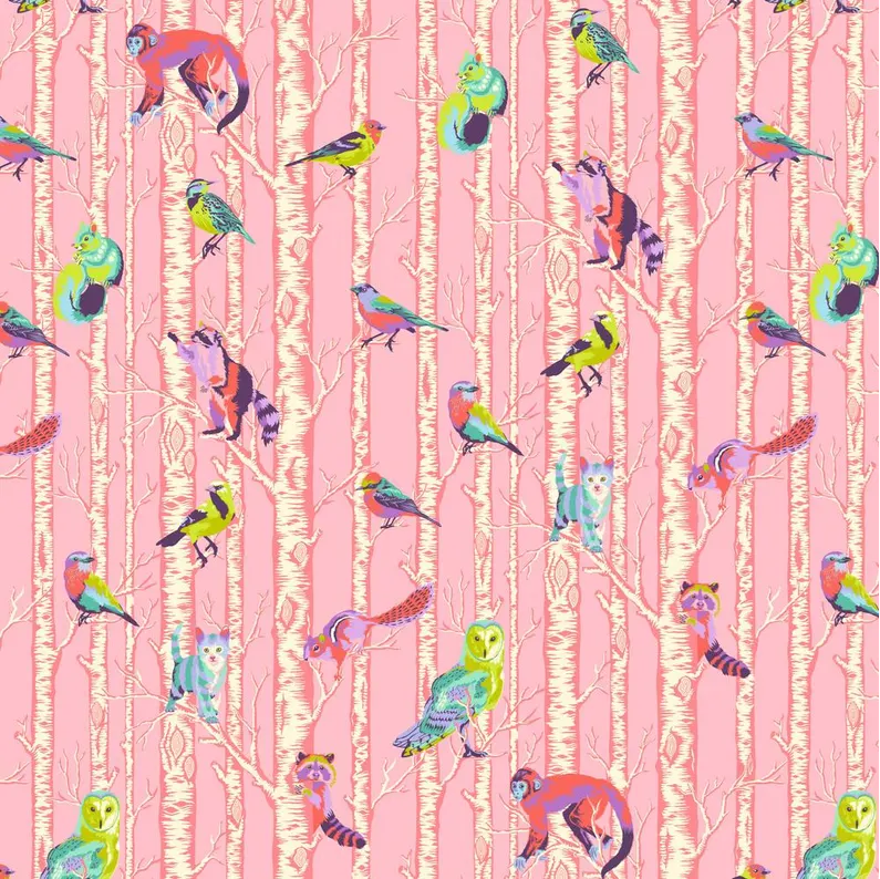 scrub cap fabric that has a colorful animal pattern on a pink background with birds and monkeys.