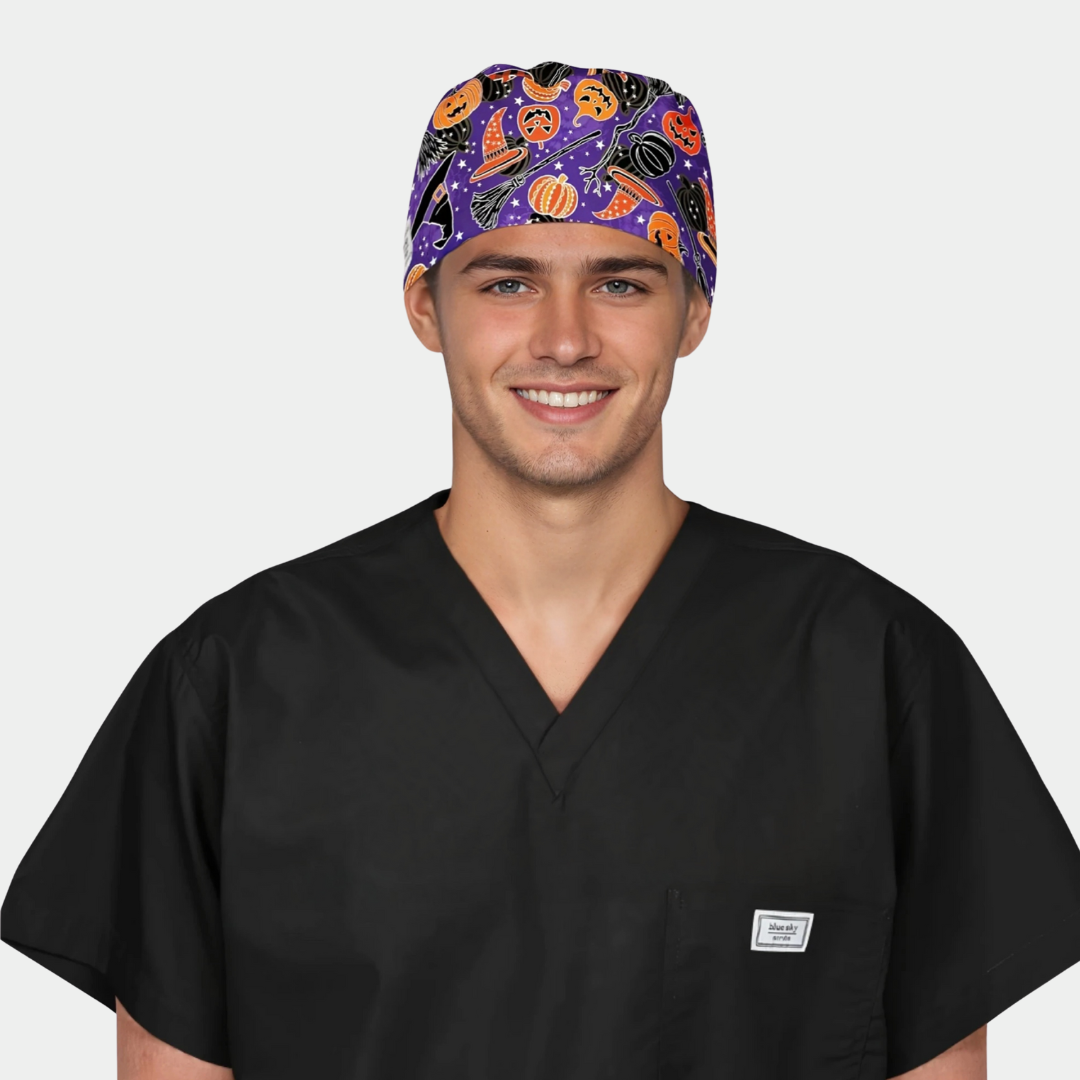 Man wearing a black scrub top and Halloween-themed scrub cap on a white background