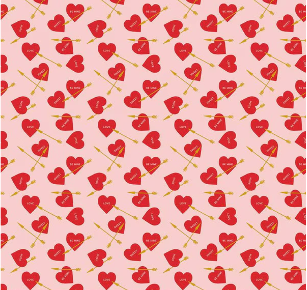Pattern of red hearts and arrows on a pink background