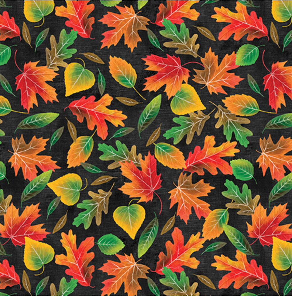 surgical scrub hat fabric with a pattern of red, orange and yellow autumn leaves on a black background