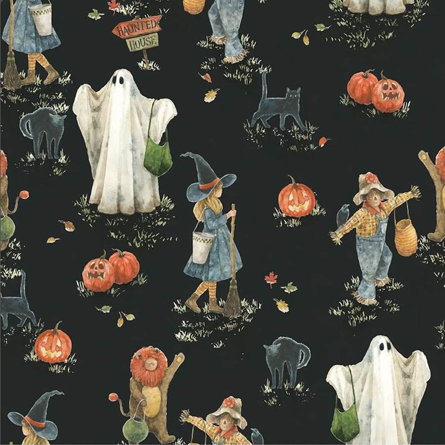 halloween scrub hat fabric that has ghosts, cats and witches on a black background